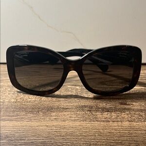 Authentic CHANEL sunglasses tortoise with black temples. Has scratches